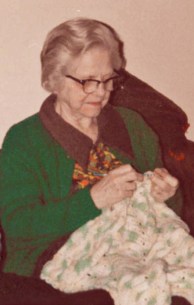 Mom crocheting a baby afghan.