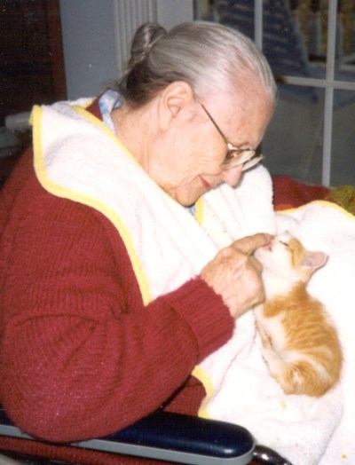 Love in action: Mim's mom, Selma, caring for a stray kitten that had been dropped off at the farm.