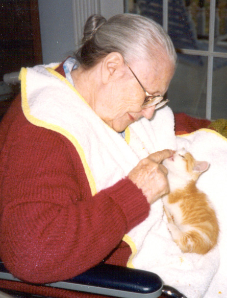 Love in action: Mim's mom, Selma, caring for a stray kitten that had been dropped off at the farm.