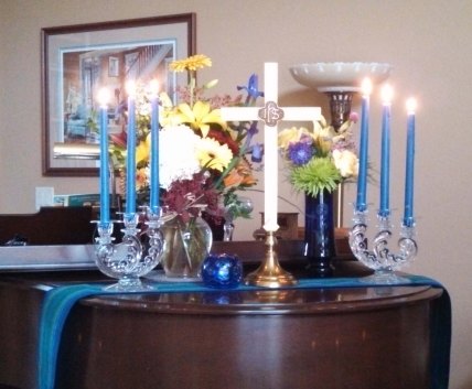 We recreated the altar on our piano at home. Something old: The candelabra were used in her parents' wedding.  Something new: The flowers. Something borrowed: The cross was borrowed from our church. Something blue: The votive candle.