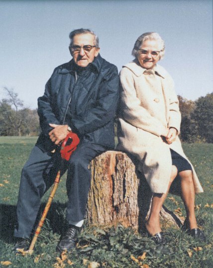 Mom and Dad resting on a stump, watching their grandsons compete in a cross country meet. Mom is wearing my coat - the one in my dream.