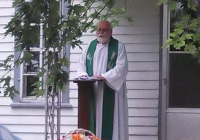The Rev. John Hagen, a former pastor of Gol, preached briefly from the steps of the farmhouse where the congregation met before the church was built.