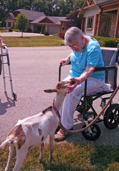 Ann and goat smiliing