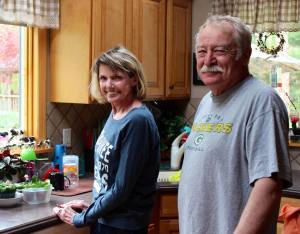 Sandy and Conrad looking out their kitchen window while hospice volunteers did spring yard work.