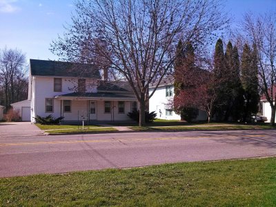 The house on the left was my grandma's. The one on the right was the Spauldings. In between was a row of deep red, pink, and white peonies.